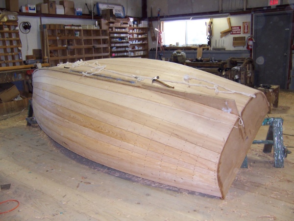 The hull is faired, caulked with cotton, plugged, and sanded.