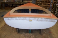 Oak coamings are steam bent on a jig and a day later installed, followed by oak rubrails.