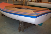 Oak coamings are steam bent on a jig and a day later installed, followed by oak rubrails.