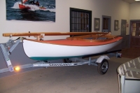 Traditional white/green Beetle Cat packaged out with trailer and spar racks.